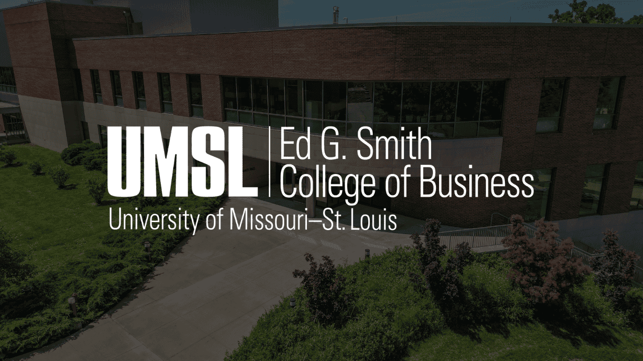 a campus building with large windows with a logo over it